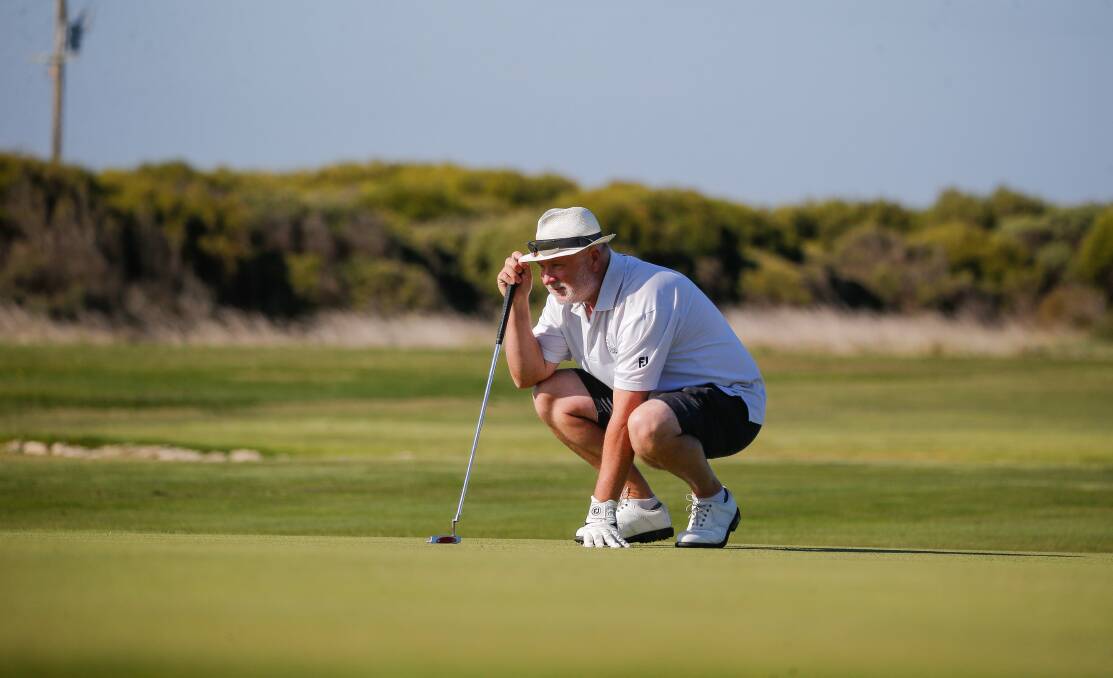 PREPARATION: Shane Gurnett lines up his putt on the 18th hole. Picture: Anthony Brady 