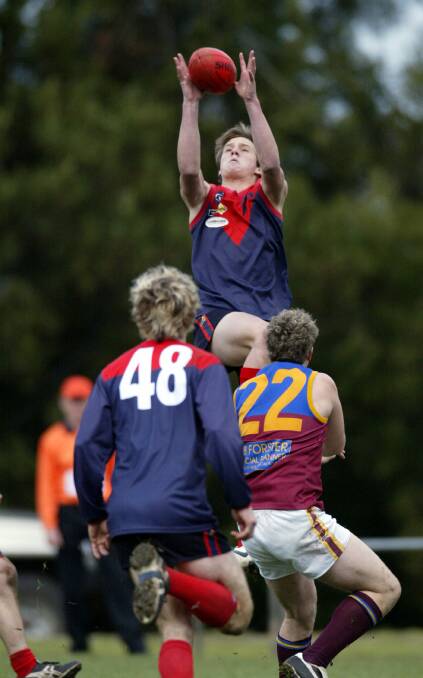 FLYING HIGH: Luke Thompson soars for a mark while playing for Warrnambool and District league club Timboon Demons in 2006.