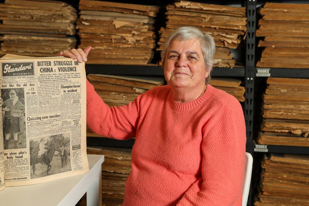 Liz Cozens pictured with a newspaper cover from the day she started - January 9, 1967. Picture by Morgan Hancock