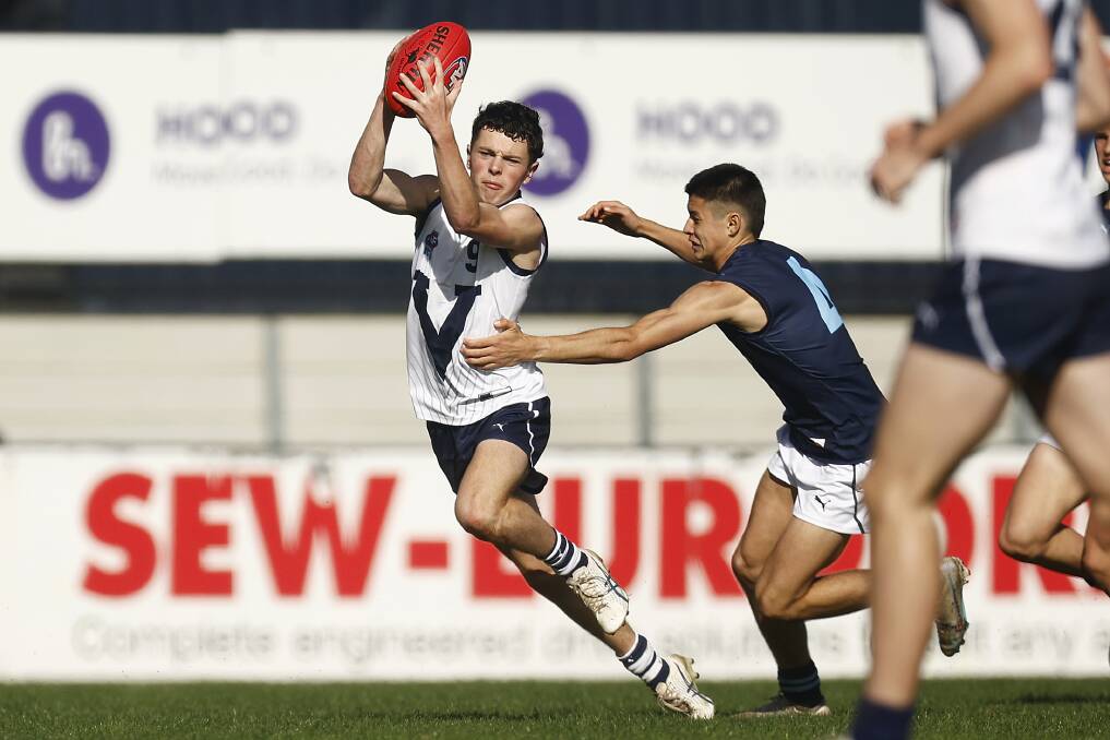 Vic Country's Archie Taylor takes on a Vic Metro tackler in the first AFL under 16 national championships match. Picture by Getty Images 