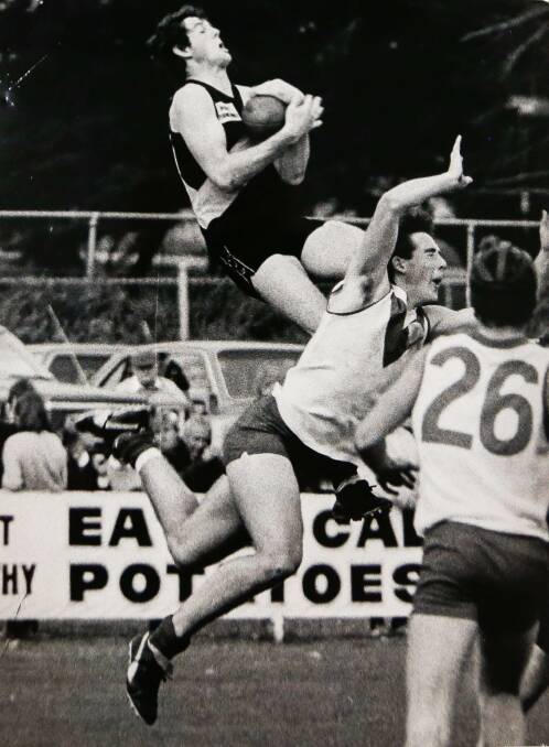 HIGH FLYER: Colac-Coragulac's Michael Williamson takes a big mark over Chris Holmes as Mark Owen looks on in the 1985 Hampden grand final. 