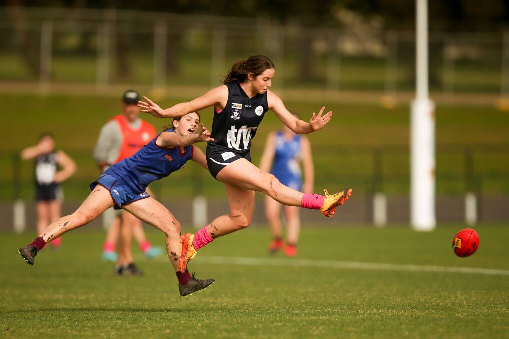 KICK AWAY: Warrnambool's Lily Jenkins boots the ball away against Horsham Demons on Sunday in the under 18 competition. Picture: Chris Doheny 