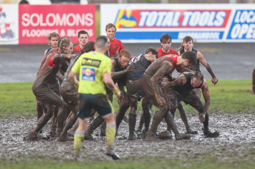 South Warrnambool and Warrnambool players caked in mud during Saturday's round 12 game at Friendly Societies' Park. Picture by Eddie Guerrero 
