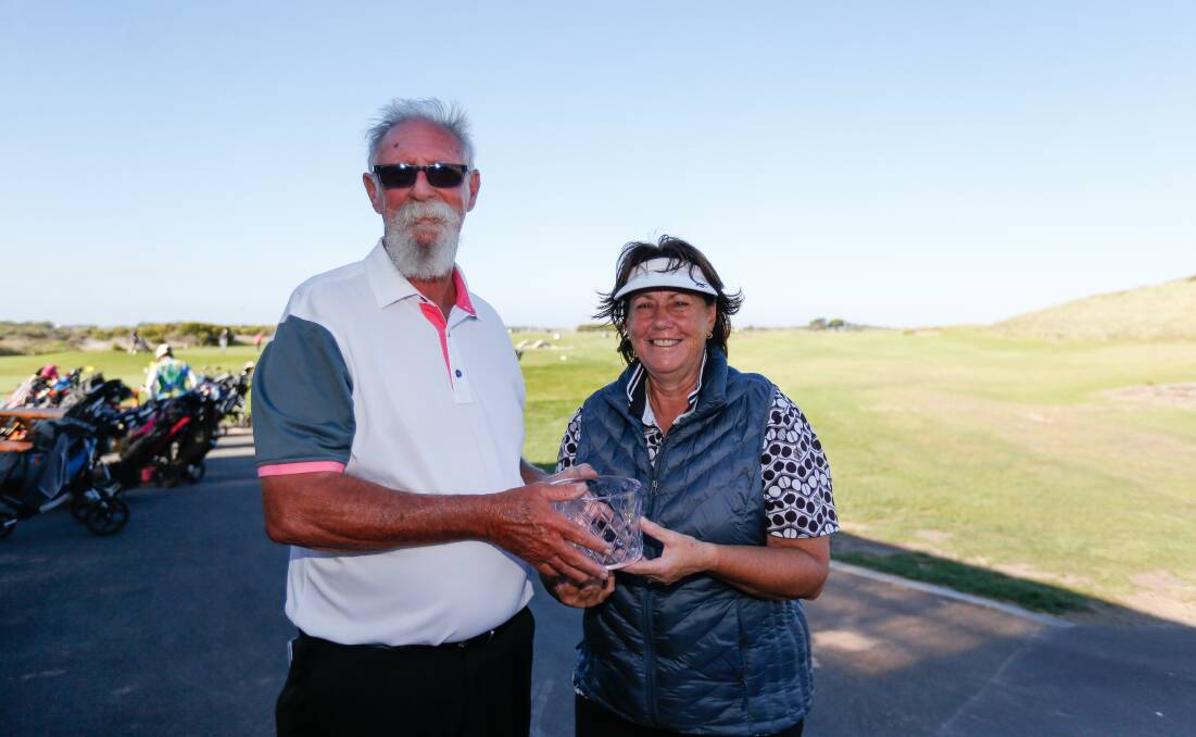 WORTHY WINNER: Port Fairy Golf Club captain John Moore presents Glenda Clarke with her trophy for winning the women's A grade title. Picture: Anthony Brady 