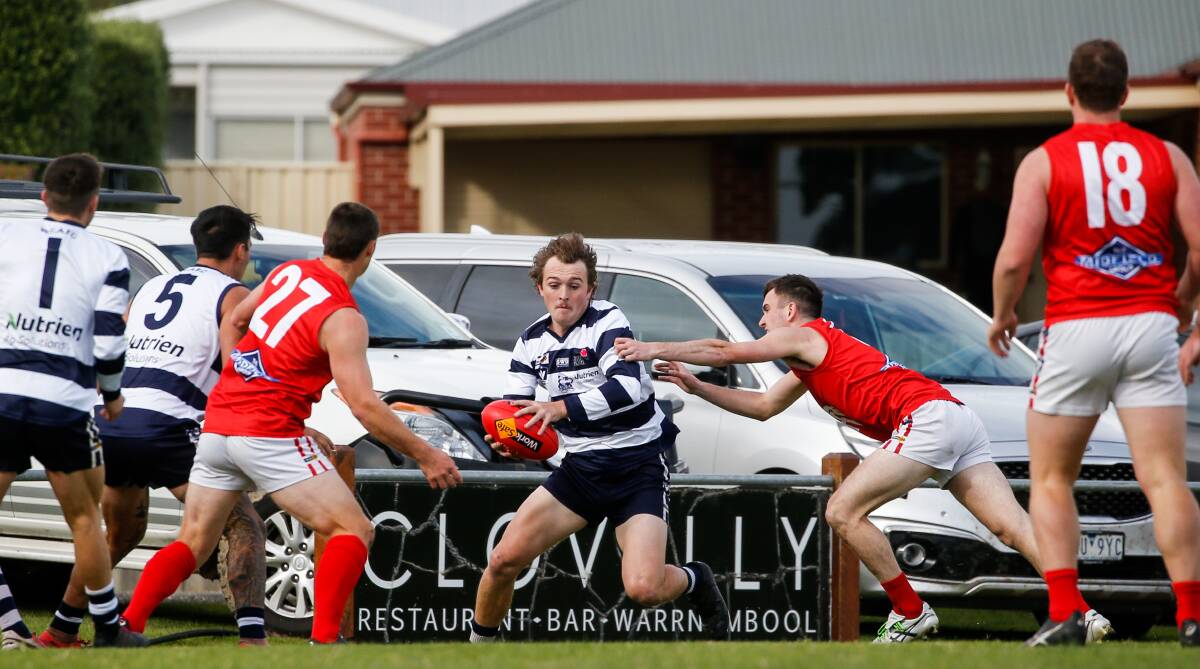 FLEET-FOOTED: Allansford's Zavier Mungean tries to evade his Dennington opponents. Picture: Anthony Brady 