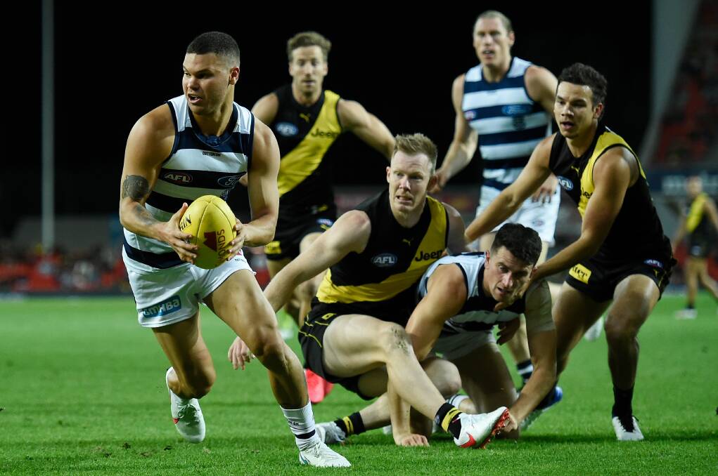 MAD SCRAMBLE: Who will win the 2020 AFL grand final - Geelong or Richmond? Cat Brandan Parfitt is pictured bursting away from a pack earlier this season. Picture: Getty Images 