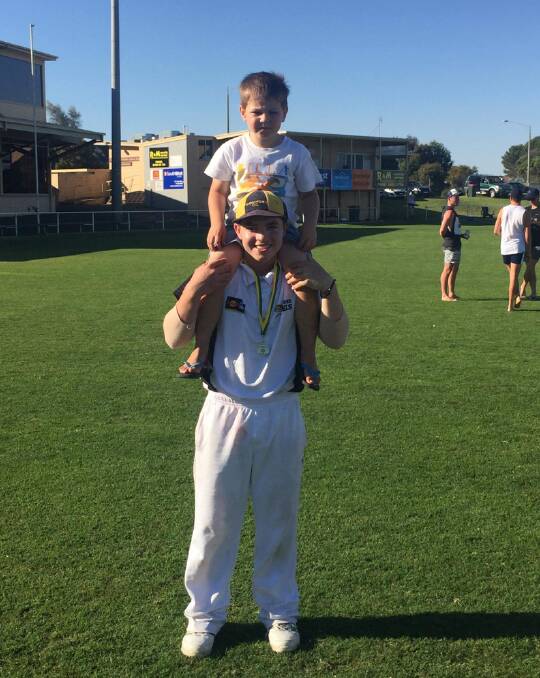 SIBLINGS: Tommy Jackson with younger brother Charlie after winning a Warrnambool and District Cricket Association premiership at Reid Oval. 