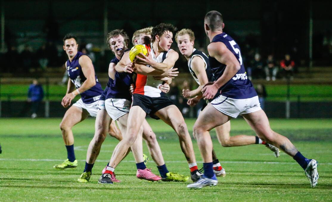 SURROUNDED: Koroit's Paddy O'Sullivan is put under pressure by Warrnambool. Picture: Anthony Brady