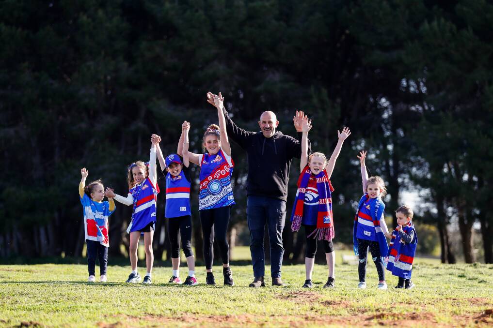 FAMILY TIES: Grandfather Alby Smedts and grandchildren Eva, Juliette, Vivienne, Charlotte, Indiana, Summer and Alby Junior are hoping for a Western Bulldogs' premiership on Saturday. Picture: Morgan Hancock 