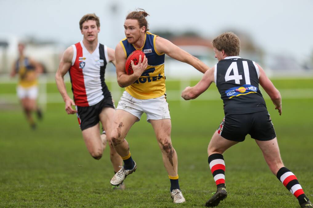 TOP TWO: North Warrnambool Eagles' Sam McKinnon in action against Koroit last season. The two sides played in the grand final. Will we see local games in 2020? Picture: Morgan Hancock
