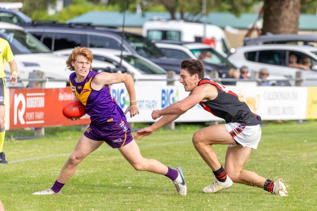 Port Fairy's Lucas King escapes the clutches of Cobden opponent Ben Berry at Gardens Oval. Picture by Eddie Guerrero 
