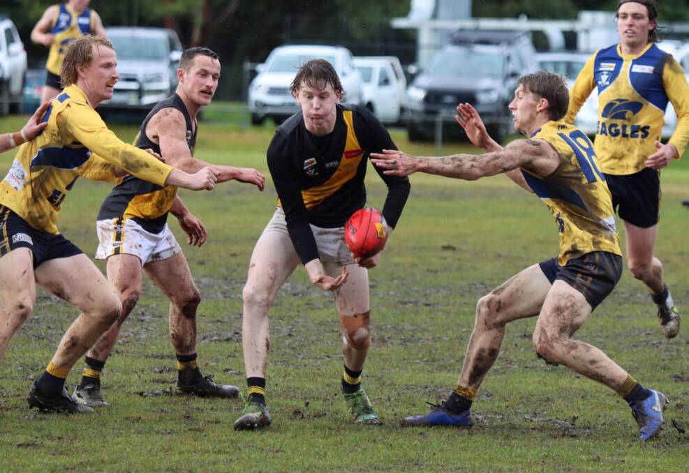 OUT OF TROUBLE: Portland's Kade Lovell works his way through traffic in its loss to North Warrnambool Eagles on Saturday. The Tigers slipped to fourth on the ladder. Picture: Justine McCullagh-Beasy
