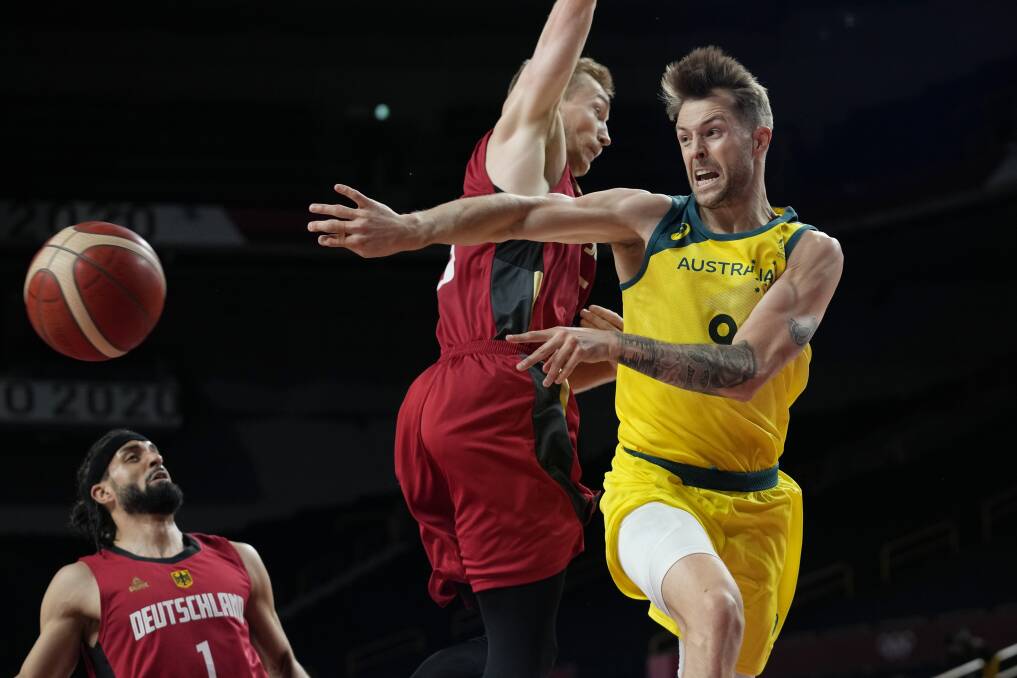 IN MOTION: Nathan Sobey dishes off a pass for Australia against Germany on Saturday night. Picture: AAP 