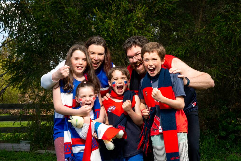 DIFFERENT SIDES: The McMahon family will be divided on AFL grand final day. Mum Natasha and daughters Grace, 10 and Annie, 4, are Bulldogs and dad Andrew and sons Edmund, 7, and Oliver, 10, are Demons. Picture: Chris Doheny 