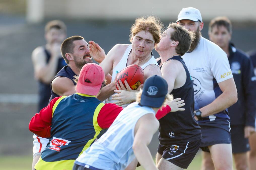 BACK AT IT: Warrnambool's Angus Lowe is tackled during Blues' pre-season earlier this year. COVID-19 training restrictions will be eased on May 25. Picture: Morgan Hancock 