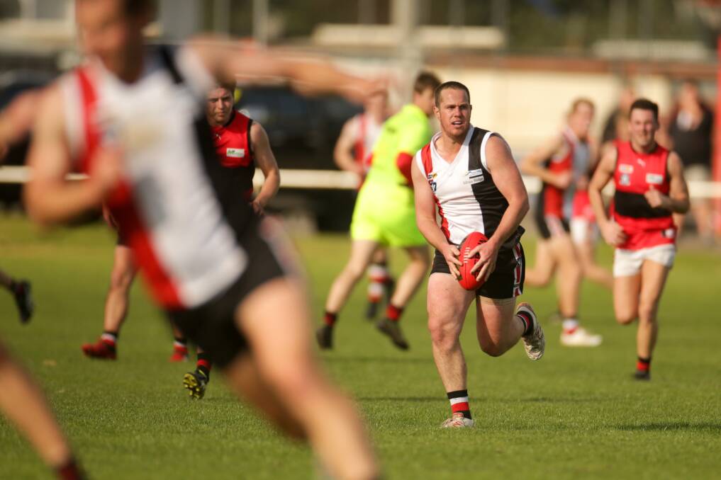 THROUGH TRAFFIC: Koroit skipper Liam Hoy searches for a teammate to pass to. Picture: Chris Doheny 