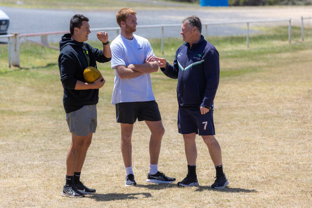 AFL players Hugh McCluggage and Willem Drew chat with Warrnambool College teacher Adam Dowie at Mack Oval. Picture by Eddie Guerrero 