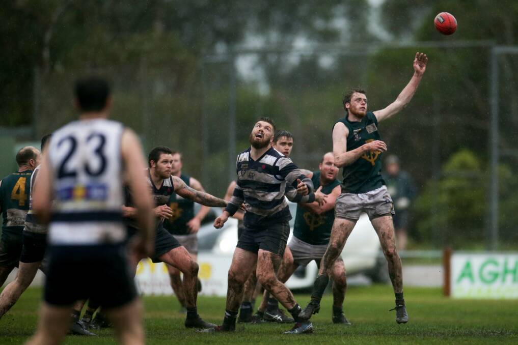 STRETCH: Old Collegians' Connor Barby tries to reel in the ball against Allansford. Picture: Chris Doheny