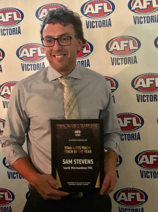 CHUFFED: Sam Stevens with his AFL Victoria youth coach of the year award on Friday night.