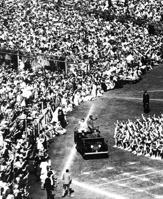 The Queen and Prince Philip wave to the huge crowd assembled at the MCG on March 4, 1954. Picture: AAP