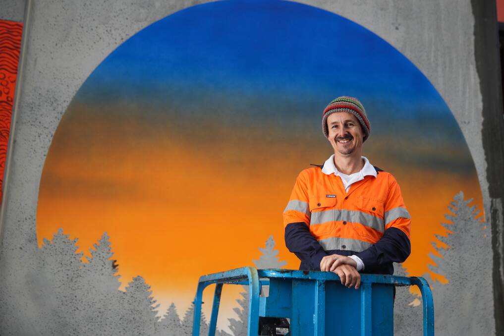 MURAL: Warrnambool artist Jimmi Buscombe is putting the finishing touches on the third mural to feature on WRAD's Merri Street wall. Picture: Morgan Hancock.