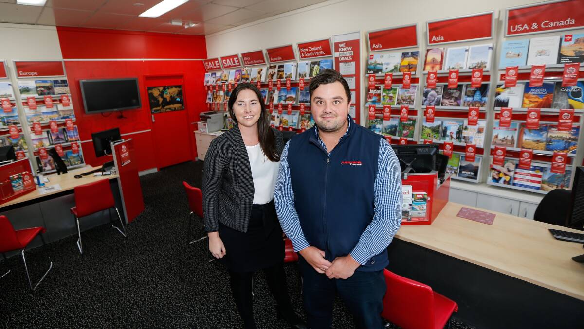 BUSY: Warrnambool Travel Centre staff Sarah Williams and Josh Campbell are reporting increases in domestic travel inquiries. Picture: Anthony Brady