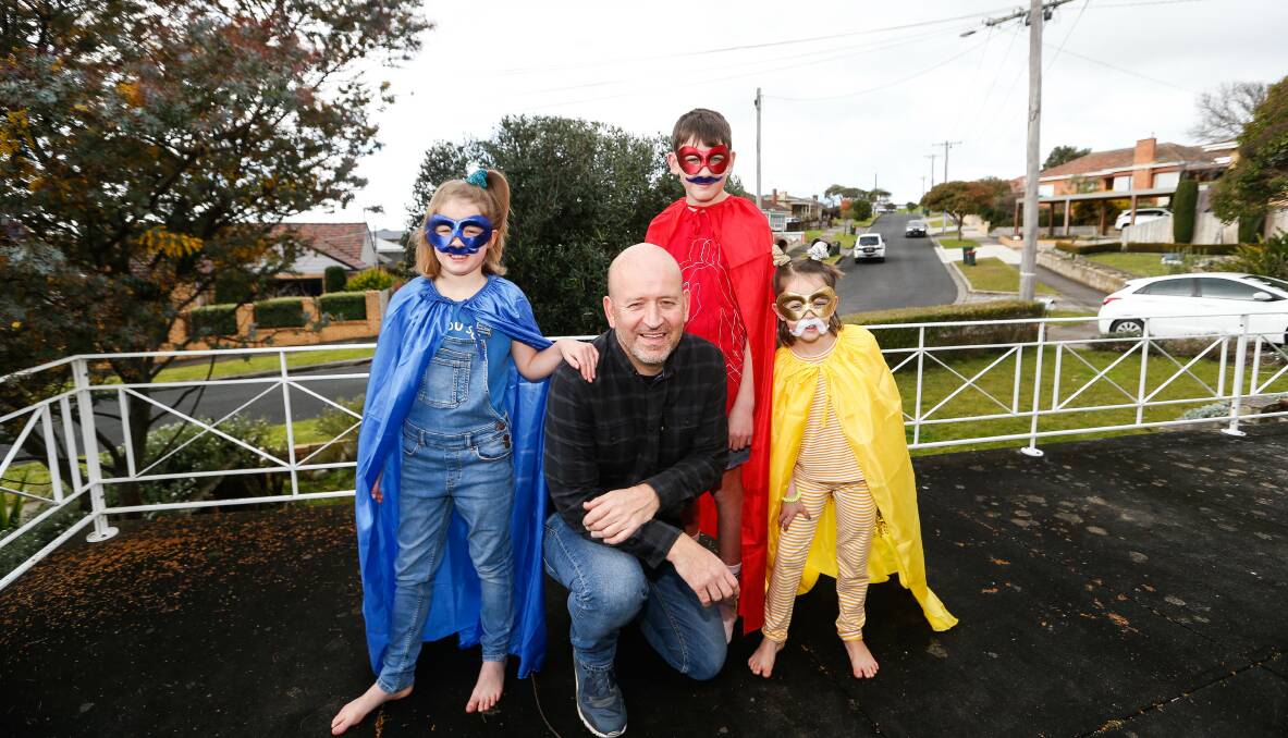 HER: Frankie, 10, Jack, 12, and Mira Brightwell, 7, were excited to get into their superhero costumes and nominate their father Mark as their hero in the Bethany Superhero Awards. Picture: Anthony Brady