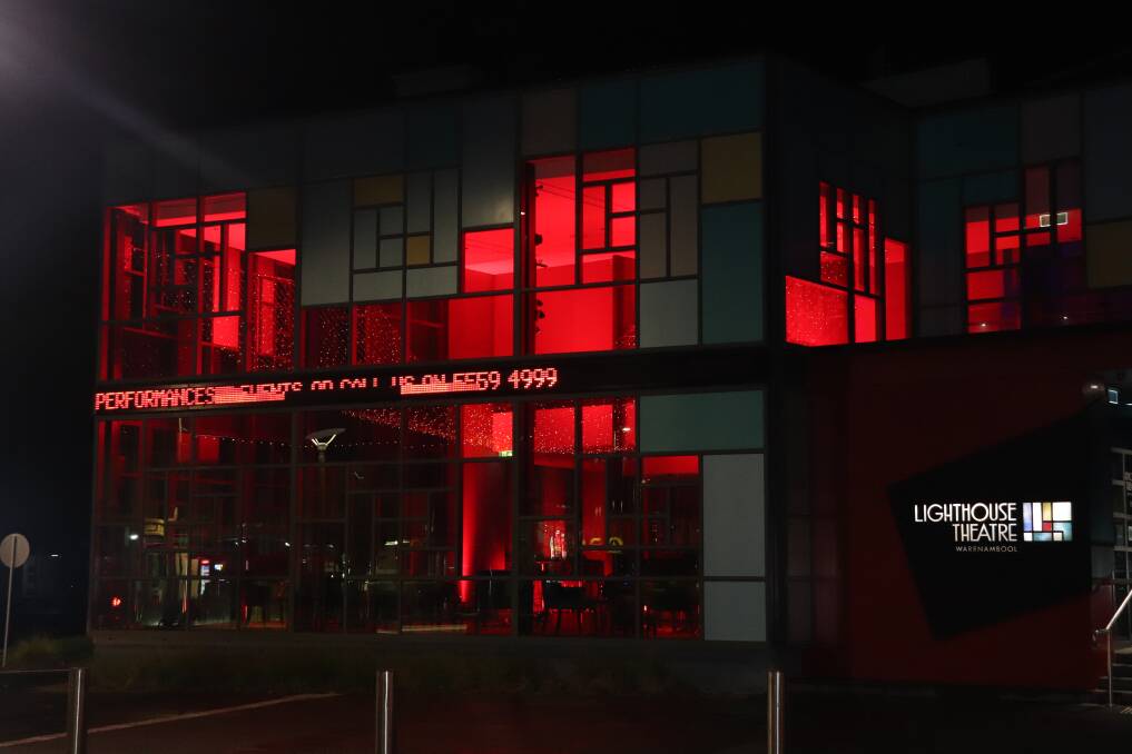 RED: The Lighthouse Theatre turned from its usual blue to red on Friday night to raise awareness for cystic fibrosis. Picture: Kimberley Price