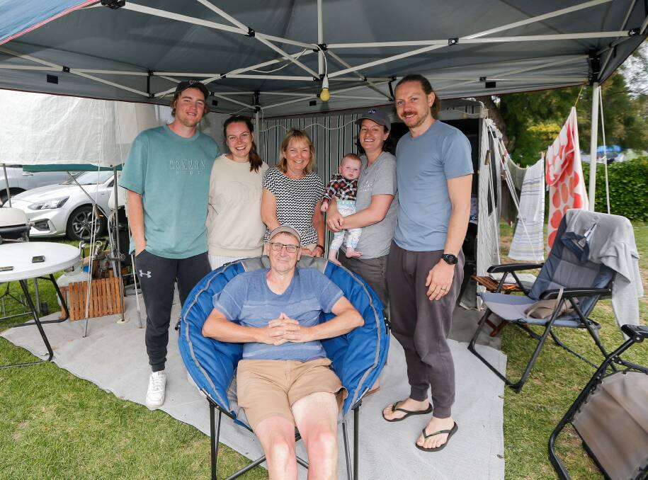 SUMMER BREAK: Kent Tomlinson relaxes in a camping chair with his family Aidan Mackie, Carly, Karen, Taryn, Daniel and Ruby Tomlinson, 5 months. Picture: Anthony Brady. 