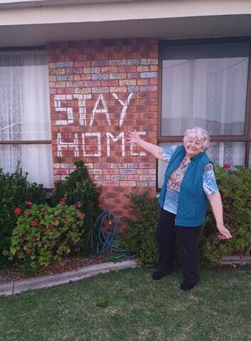 Joan Stevenson with her decorated wall.