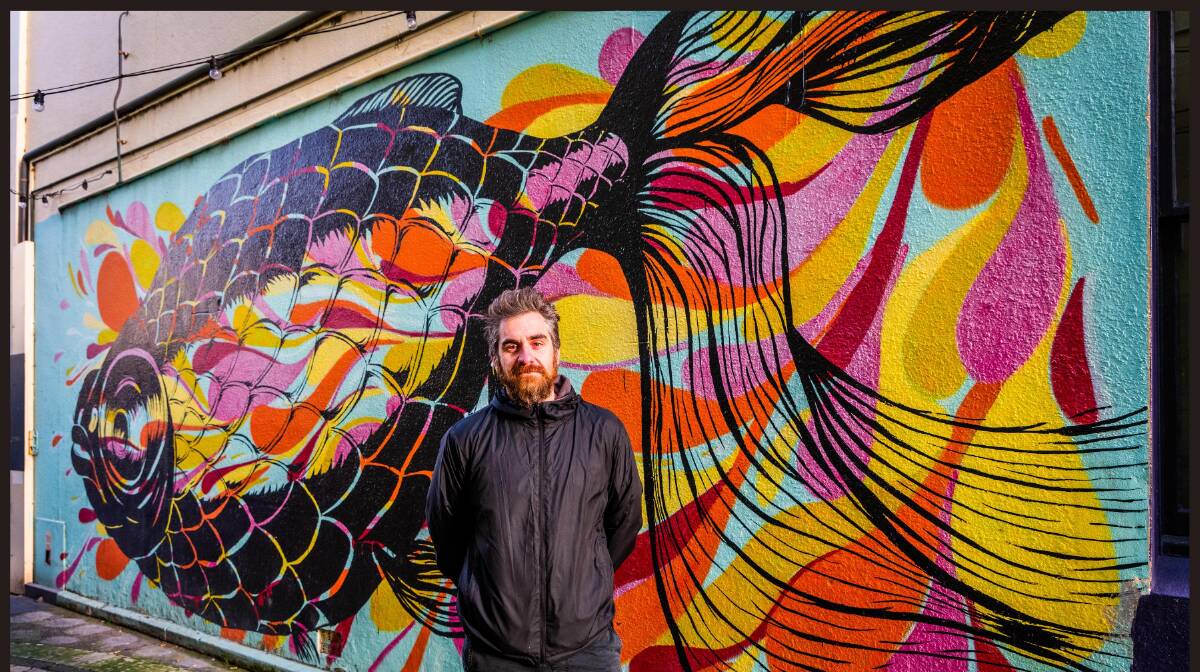 Warrnambool artist Nathan Pye in front of his Patloch Lane mural.