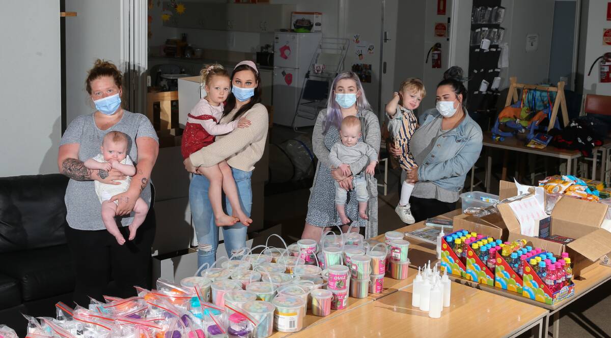 South West TAFE VCAL young parents group Tyler Searle with Charlie-Jay Searle, 4 months, Rehn Laidlord with Charlotte Walker, 4, Lily Walker with Fox, 8 months, and Grace Oldham with Oscar Smith, 3, where they are making the Funabool boxes. Picture: Mark Witte