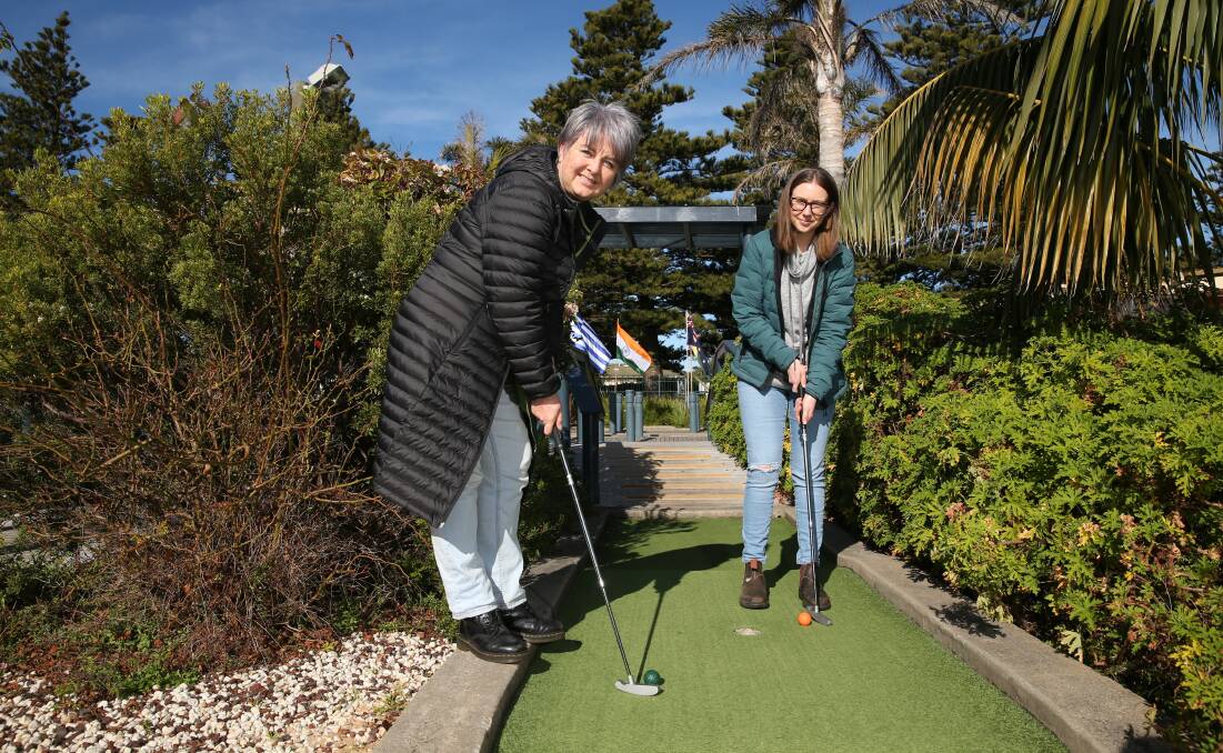 Mini Golf by the Sea owner Jane Holland and daughter Sadie play a round. Picture: Mark Witte