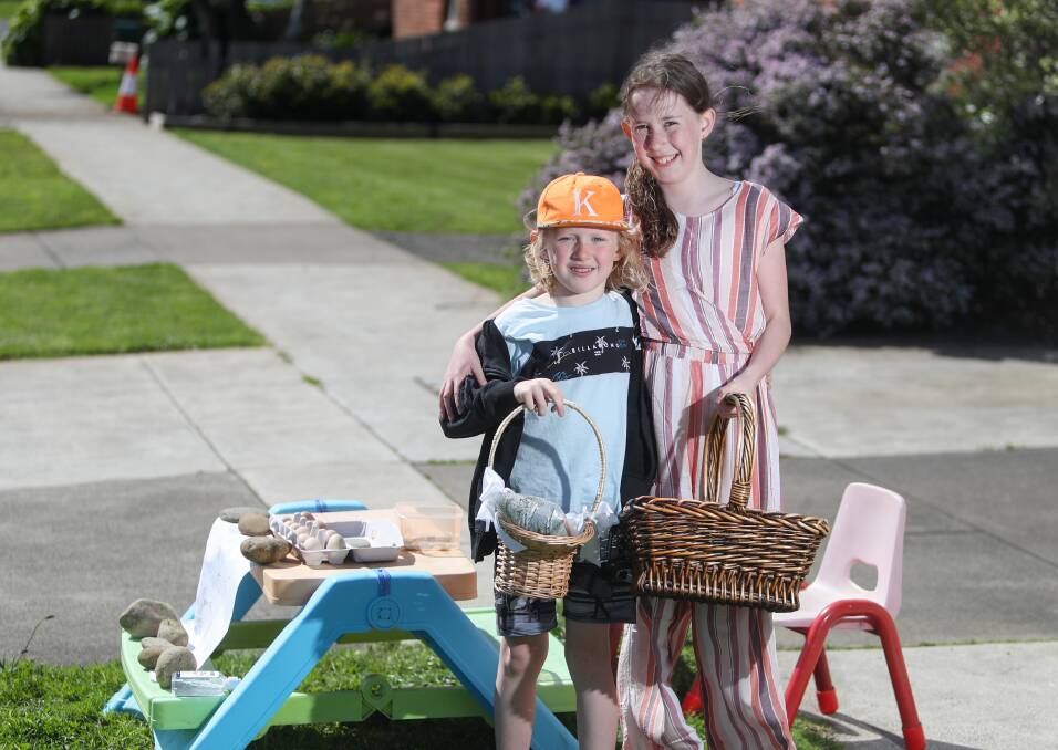 Ebony, 11, and Kyson, 7, Rogers are selling produce outside their home for school holiday fun. Picture: Morgan Hancock