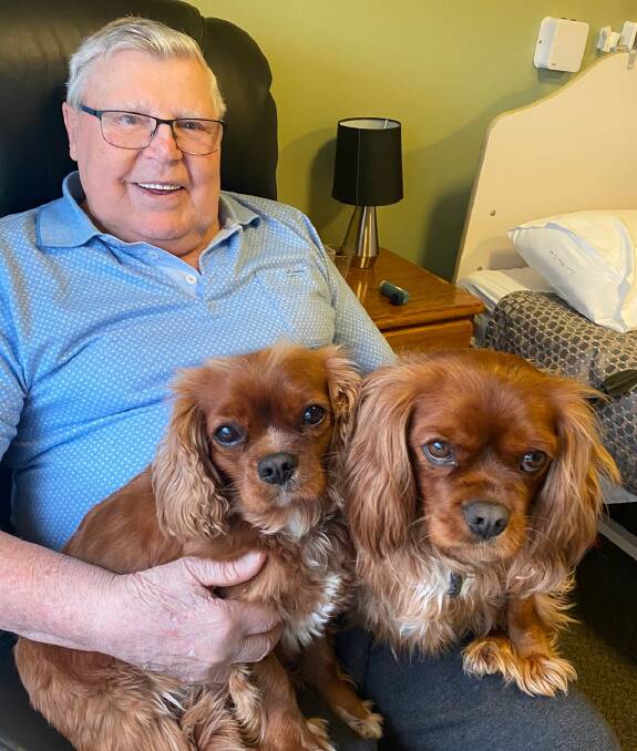 Lyndoch Living resident Dennis Saunders with the therapy dogs Jax and Oscar.
