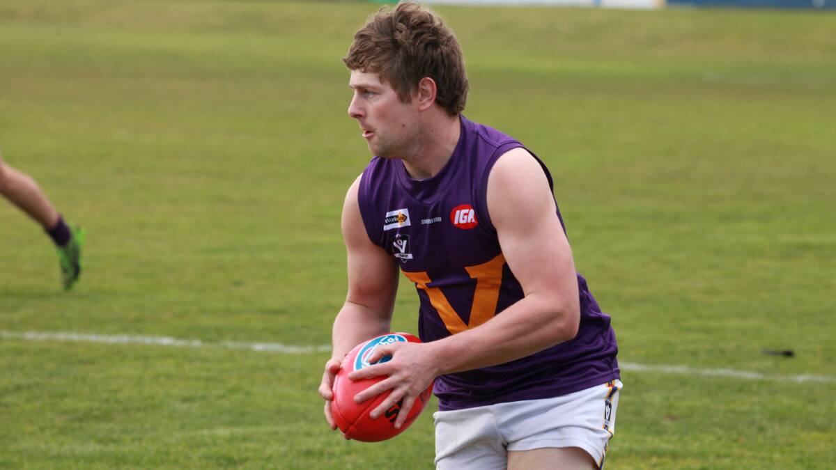 ON THE MOVE: Nick Sheehan looks to move the ball for Port Fairy during last year's HFNL second semi-final.