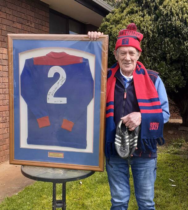 CHERISHED: Warrnambool's Peter Graetz with a signed 1984 Melbourne Demons jumper from the late, great Robbie Flower and his football boots.