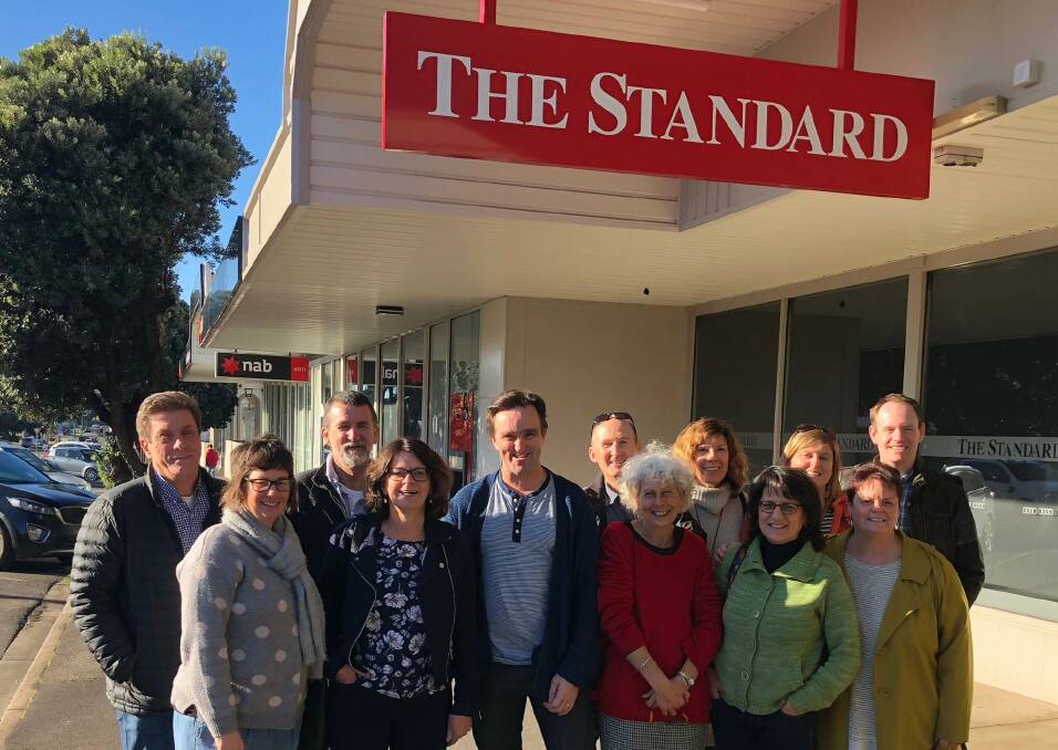 VETERAN SNAPPER: Long-time photographer Damian White (centre) with some of his former colleagues at The Standard in 2018. 