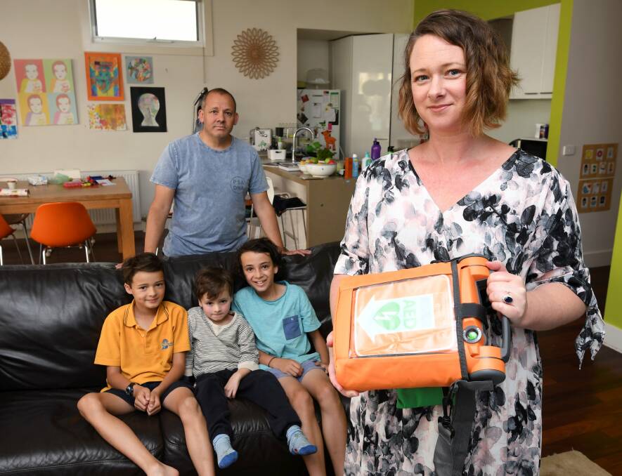 DEFIBRILLATOR: Stephanie Wilson holds one of the defibrillators that she hopes never to use. Sons Lewis, 9, and Jasper, 4, and her husband Neil have hypertrophic cardiomyopathy which thickens their heart walls. Picture: Lachlan Bence