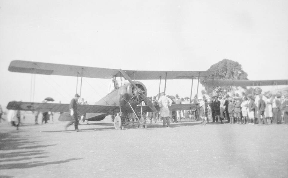 Crowds admire the plane after it arrived in Adelaide. Picture supplied by the State Library of South Australia, B 3456, PRG 1218/3 or OH 456/1.