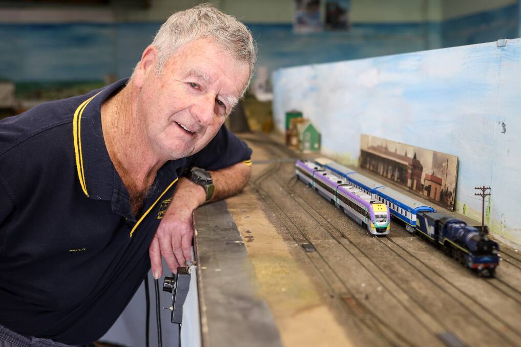 Warrnambool Model Railway Club president Max Sharrock with a model of the new VLocity trains and the old privately-run West Coast Railways trains. Picture by Anthony Brady