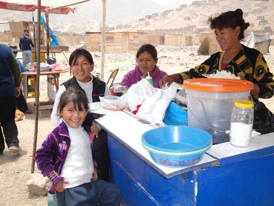 Dinner time: Father Michael McKinnon set up 12 food kitchens in Peru during his time there.