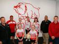Hansen Yuncken's Stephen Keen and Garry Sheppard with Dennington president Anthony Dowd, netballers (back) Zalhi Brookes, Ruby Wright, Amber Dowd, (front) Lily Vickery, Indy Vickery, and committee member Brad Rantall. Picture by Anthony Brady
