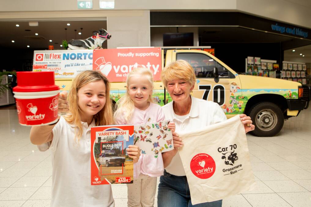 Fundraiser: Cathy Anderson - with the help of Milly Tate, 12, and Alvie Maher, 3, - is raising money for Australia's most famous motor charity event Variety Bash by getting kids to put stickers on her car. Picture: Chris Doheny 