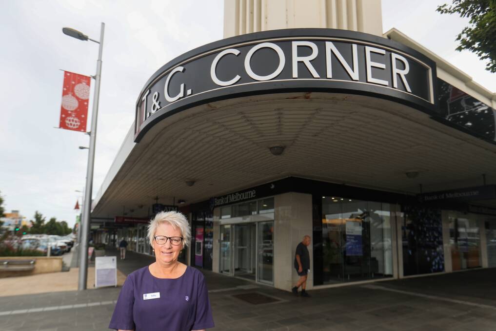 It's back: Bank of Melbourne branch manager Kathy Brady with the new T&G Corner sign that was installed on a prominent Liebig Street corner. Picture Morgan Hancock