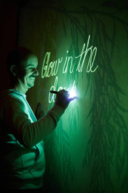 Even mobile phone torches can be used to write on the glow-in-the-dark wall which was painted by artist Jimmi Buscombe. Picture supplied