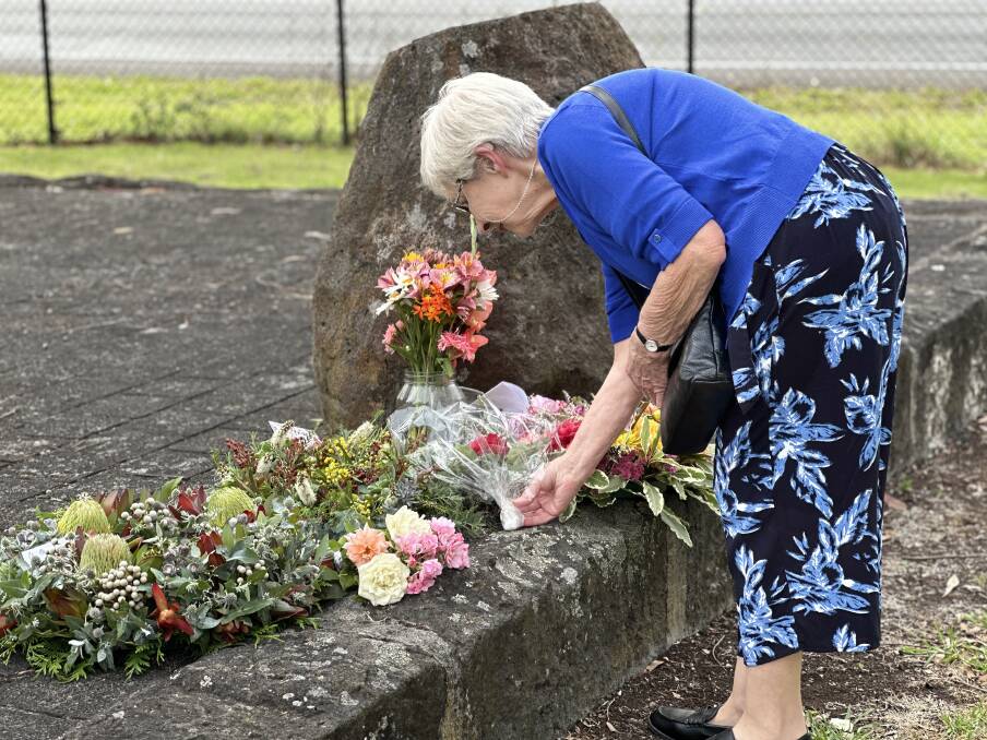 Bev Moore places some flowers at the Panmure memorial on Thursday.