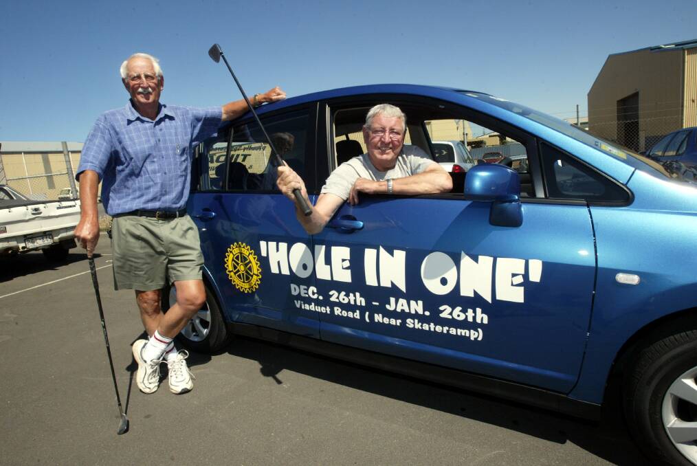 Rotary's Ian Heard with Pat Gleeson who donated a new Nissan Tiida for the Hole-in-one competition. 