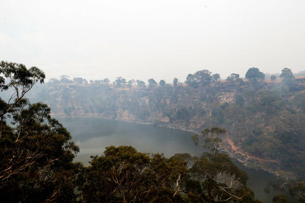 Smoke surrounds the crater of Lake Surprise at the Budj Bim National Park. Picture: Anthony Brady