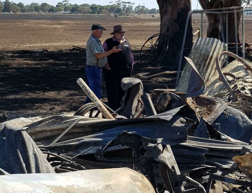 Get ready: Corangamite mayor Neil Trotter, inspecting fire damage with farmer Ian Grummett, has urged people in Timboon to get fire plans ready. 